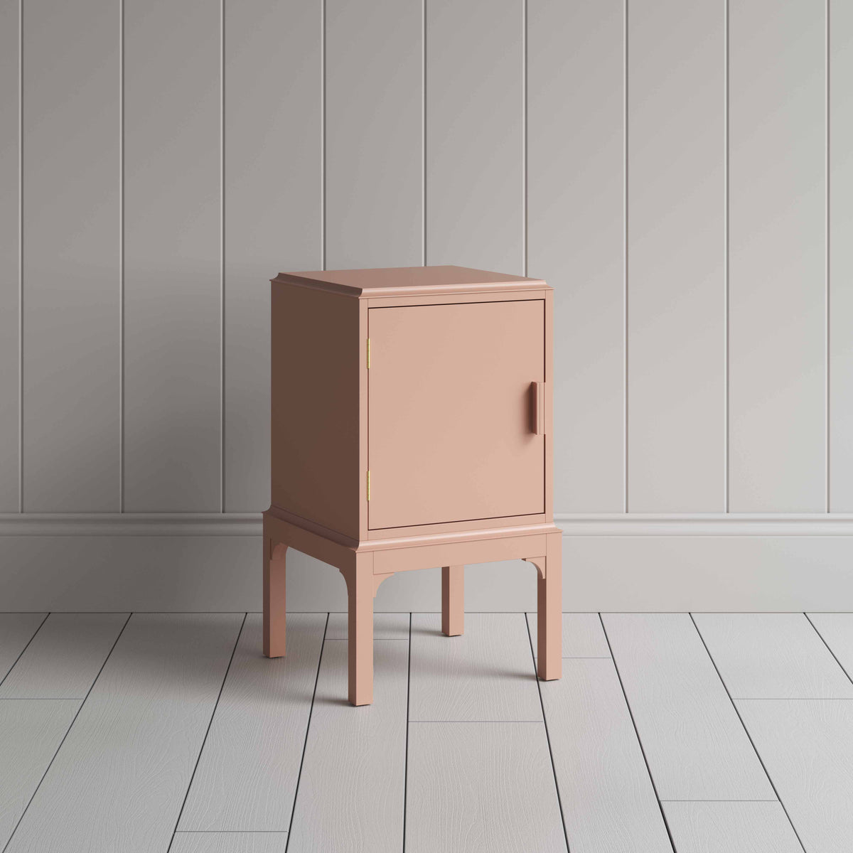 A small pink bedside table with a side door, perfect for storing items discreetly and adding a pop of color to any room.