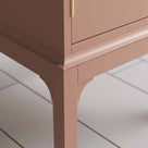 Edge Design close up of a small pink bedside table with a side door, perfect for storing items 