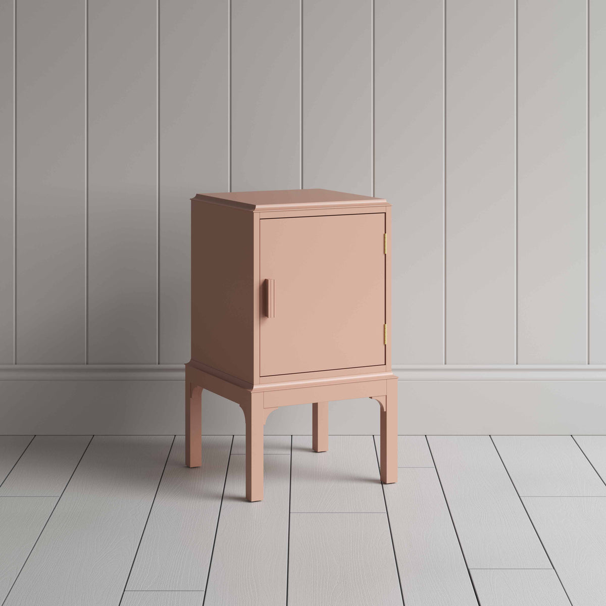 A small pink bedside table with a side door, perfect for storing items discreetly and adding a pop of color to any room.
