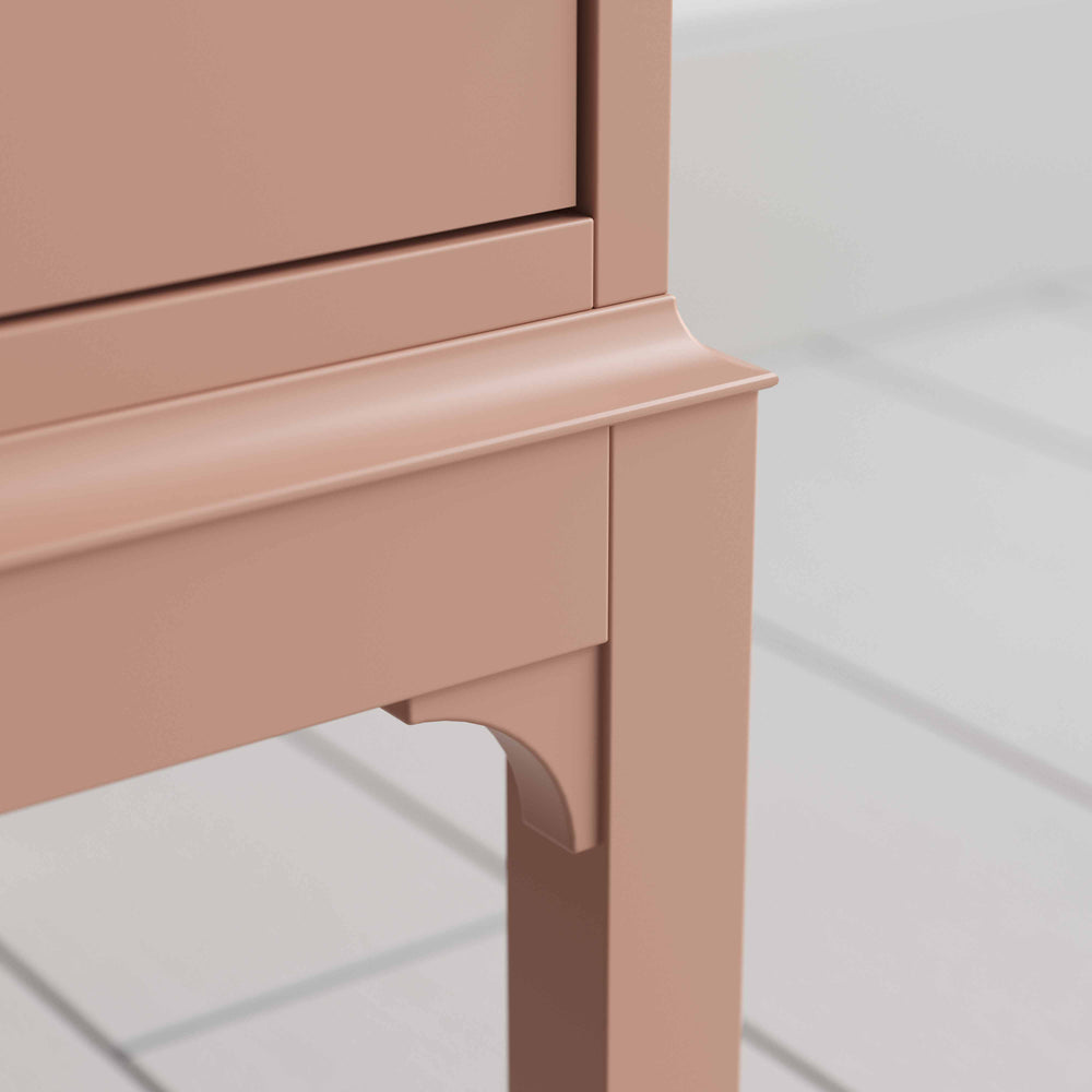 A close up of small pink bedside table with a side door, perfect for storing items - By NiX Studio