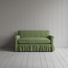 Front view of Curtain Call loveseat in green and wine Colonnade Cotton with ruffled skirt