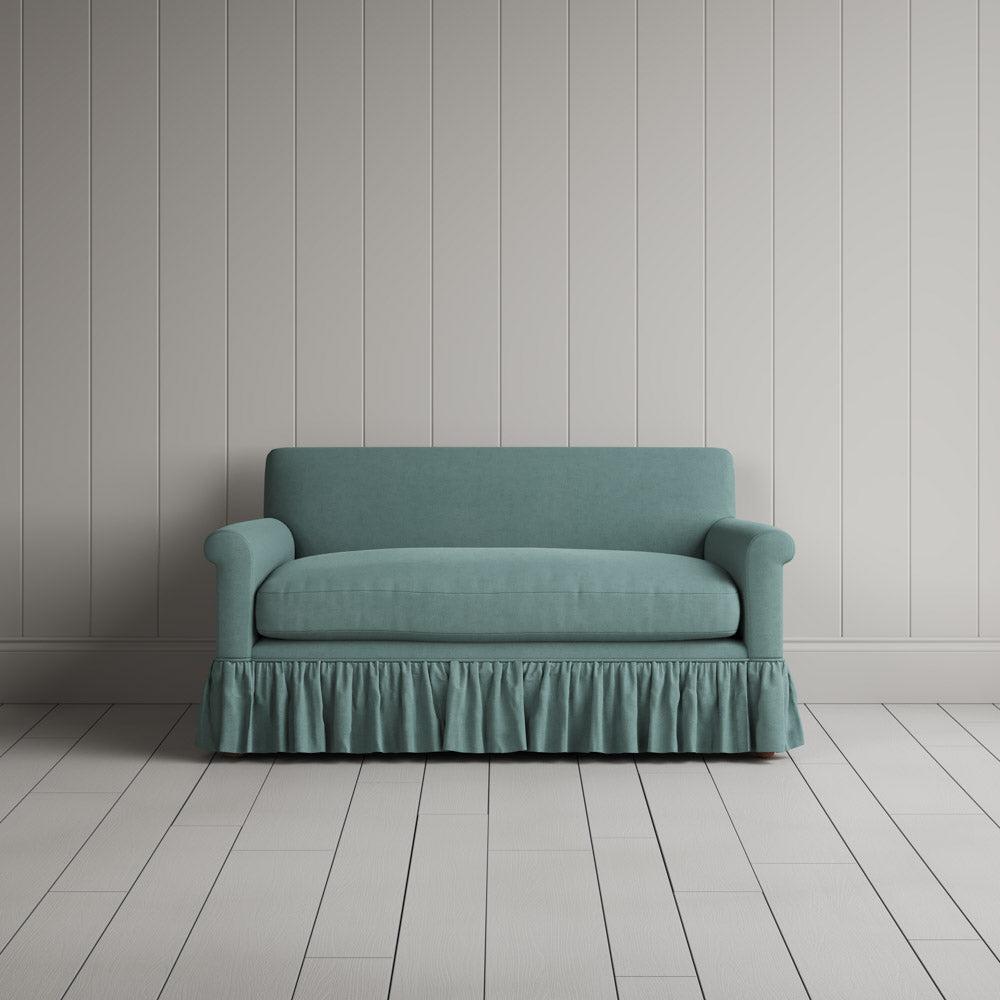 Nix by Nicola Harding Curtain Call love seat upholstered in cerulean linen with ruffled skirt