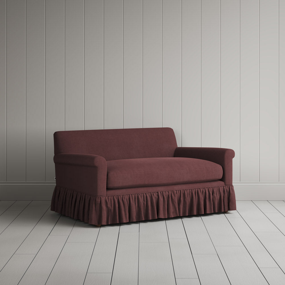 Three-quarter view of the Laidback Linen Damson Curtain Call love seat by NiX.