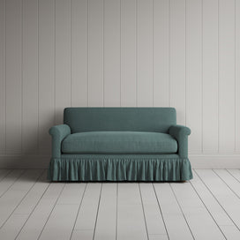 Front view of the Mineral linen nix sofa highlighting its gathered skirt base.