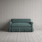 Front view of the Mineral linen nix sofa highlighting its gathered skirt base.
