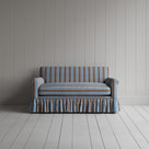 Front view of the blue cotton NiX sofa highlighting its gathered skirt base.