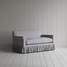 Angled shot of a blue and brown striped curtain call love seats by Nicola Harding.