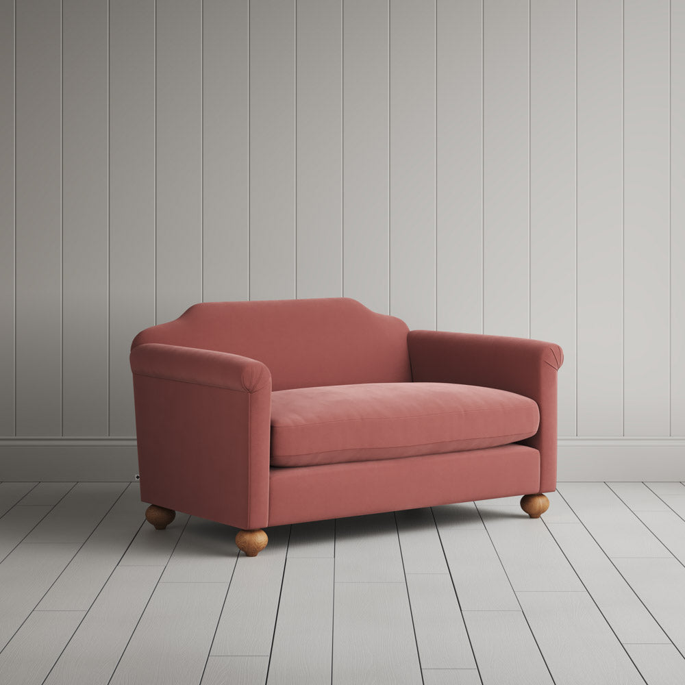Angled shot of a luxury velvet upholstered love seats by Nicola Harding.