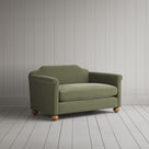 Three-quarter view of the light green velvet Dolittle love seat by NiX.