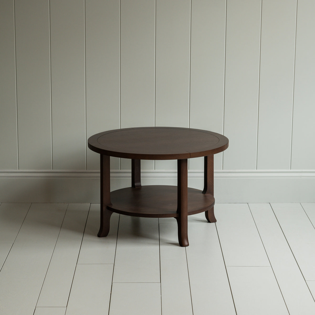 A circular wooden table with sturdy wooden base.