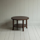 A circular wooden table with sturdy wooden base.