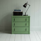 Shipshape Chest of Drawers, Sage Green With Opened Drawers With Books and Brass Lamp on the top Front View - By NiX