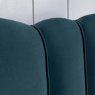 Close-up of the upholstery design on the bed in Intelligent Velvet Aegean fabric, showcasing the sewing details.