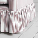Detailed view of the gathered ruffle skirt and lower base on the Curtain Call sofa by NiX.