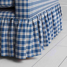 Detailed view of the gathered ruffle skirt and lower base on the Curtain Call sofa by NiX.