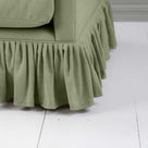 Detailed view of the gathered ruffle skirt and lower base on the Curtain Call sofa by NiX.