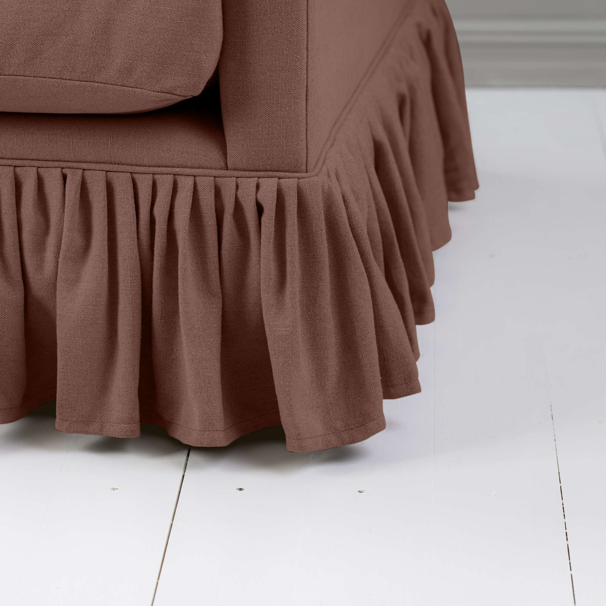  Detailed view of the gathered ruffle skirt on the Curtain Call sofa by NiX. 