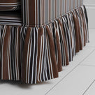 Detailed view of the gathered ruffle skirt and lower base on the Curtain Call sofa by NiX.