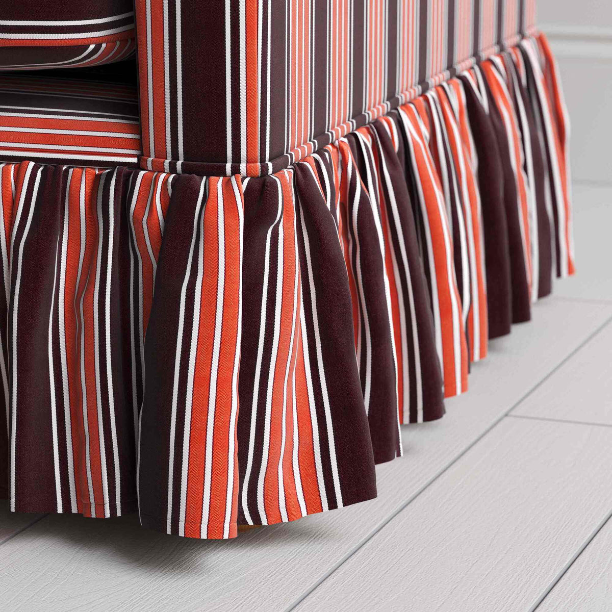 Detailed view of the gathered ruffle skirt and lower base on the Curtain Call sofa by NiX.
