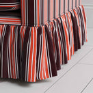 Detailed view of the gathered ruffle skirt and lower base on the Curtain Call sofa by NiX.