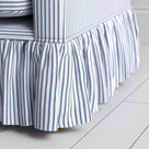 Detailed view of the gathered ruffle skirt and lower base on the Curtain Call sofa by NiX.