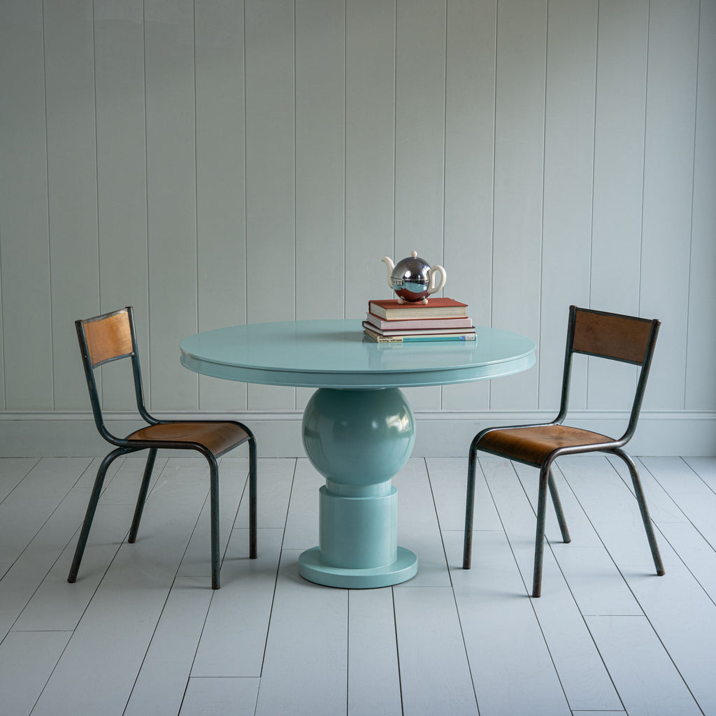  Raconteur Dining Table in Glacier Blue With Books on it 