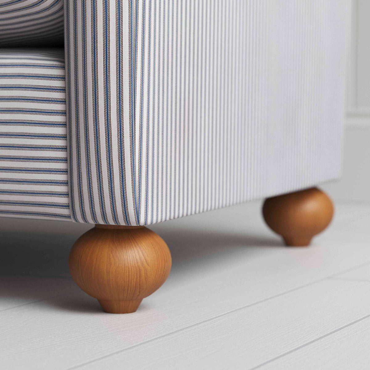 Wooden Foot Design Closeup of NiX Seating in Ticking Blue Brown Cotton fabric – Nicola Harding & Co