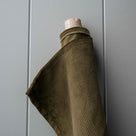 Roll of Caper Classic Corduroy fabric for bespoke Nicola Harding upholstery.
