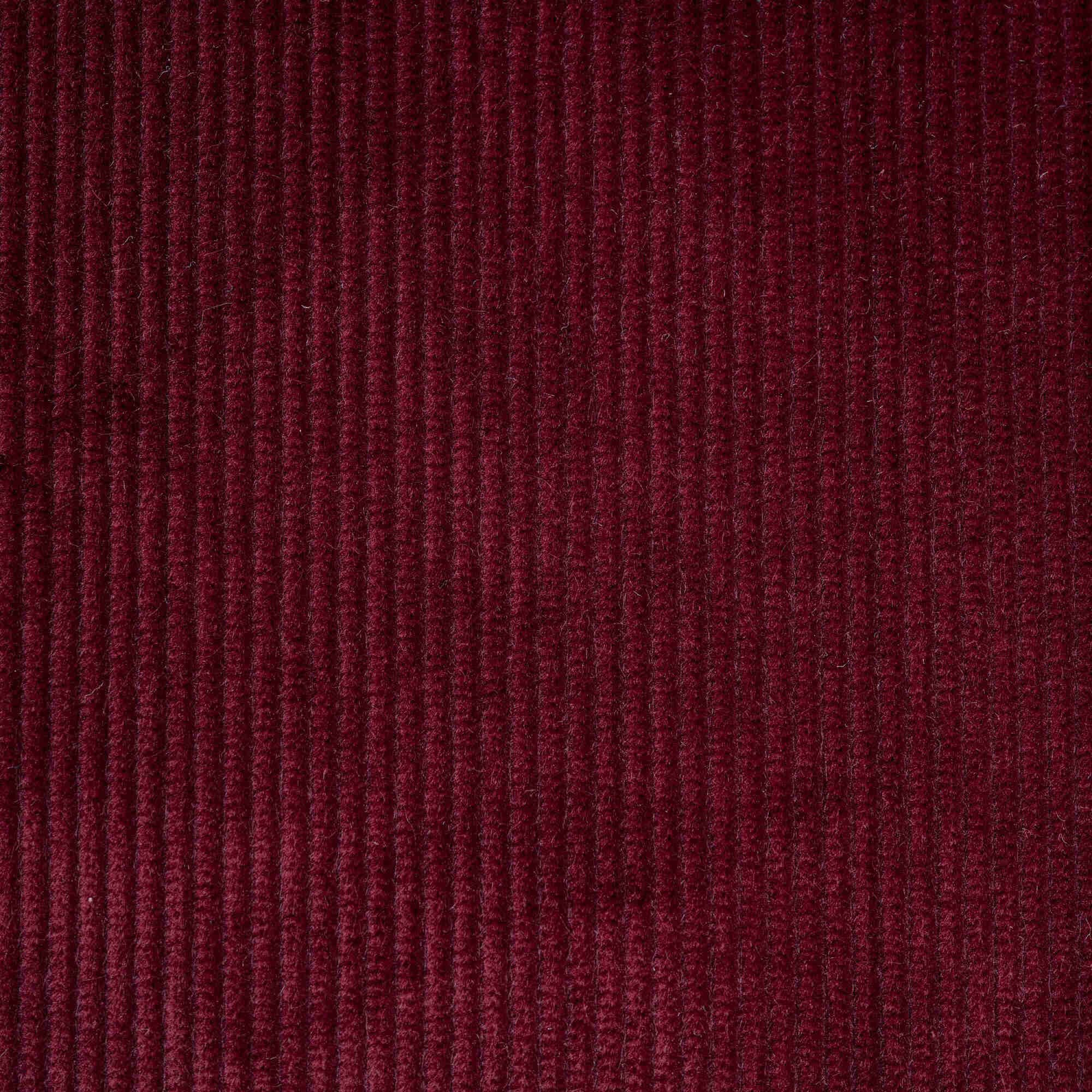  Flat lay of Cherry Classic Corduroy, a warm red ribbed cotton fabric for luxury seating. 