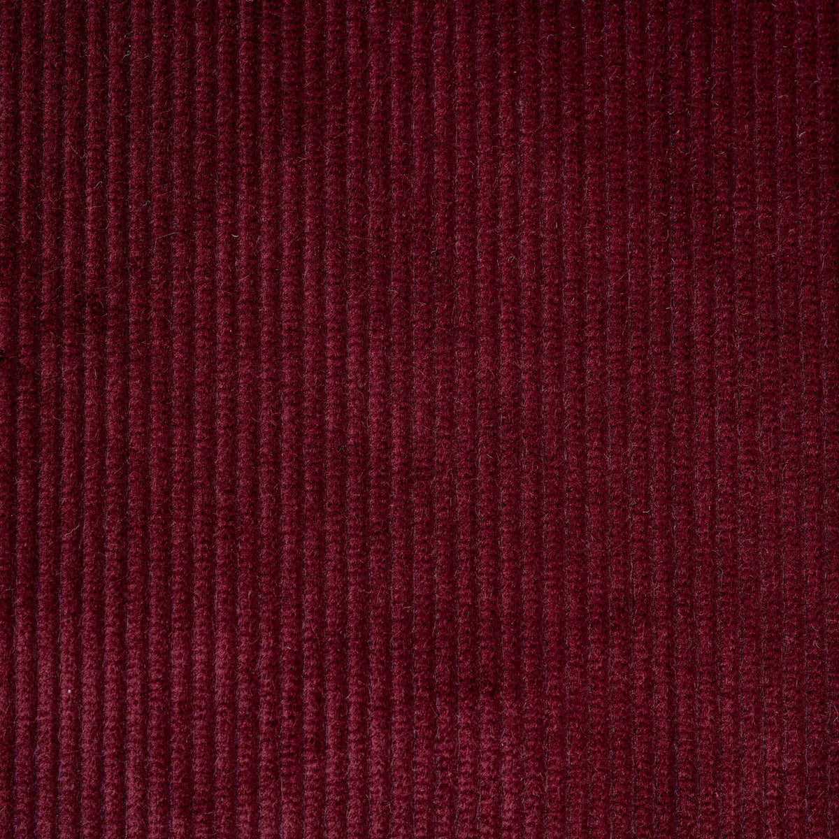 Flat lay of Cherry Classic Corduroy, a warm red ribbed cotton fabric for luxury seating.