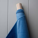 Roll of Harbour Blue Classic Corduroy fabric for bespoke Nicola Harding upholstery.
