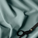 A pair of scissors on a blue Laidback Linen Mineral Fabric - By NiX