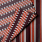 Detailed view of folded Flame Regatta cotton material by Nicola Harding.