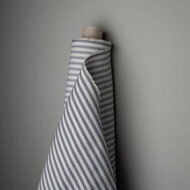 A striped fabric roll in white and grey colors.