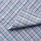 Softly folded Square Deal Cotton fabric highlighting the unique pattern of a NiX sofa.