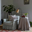 To The Point Floor Lamp Base in Waxed Brass, With Dotted Lampshade Next to a Side Table and an Curtain Call Arm Chair With 2 NiX Cushions - By NiX