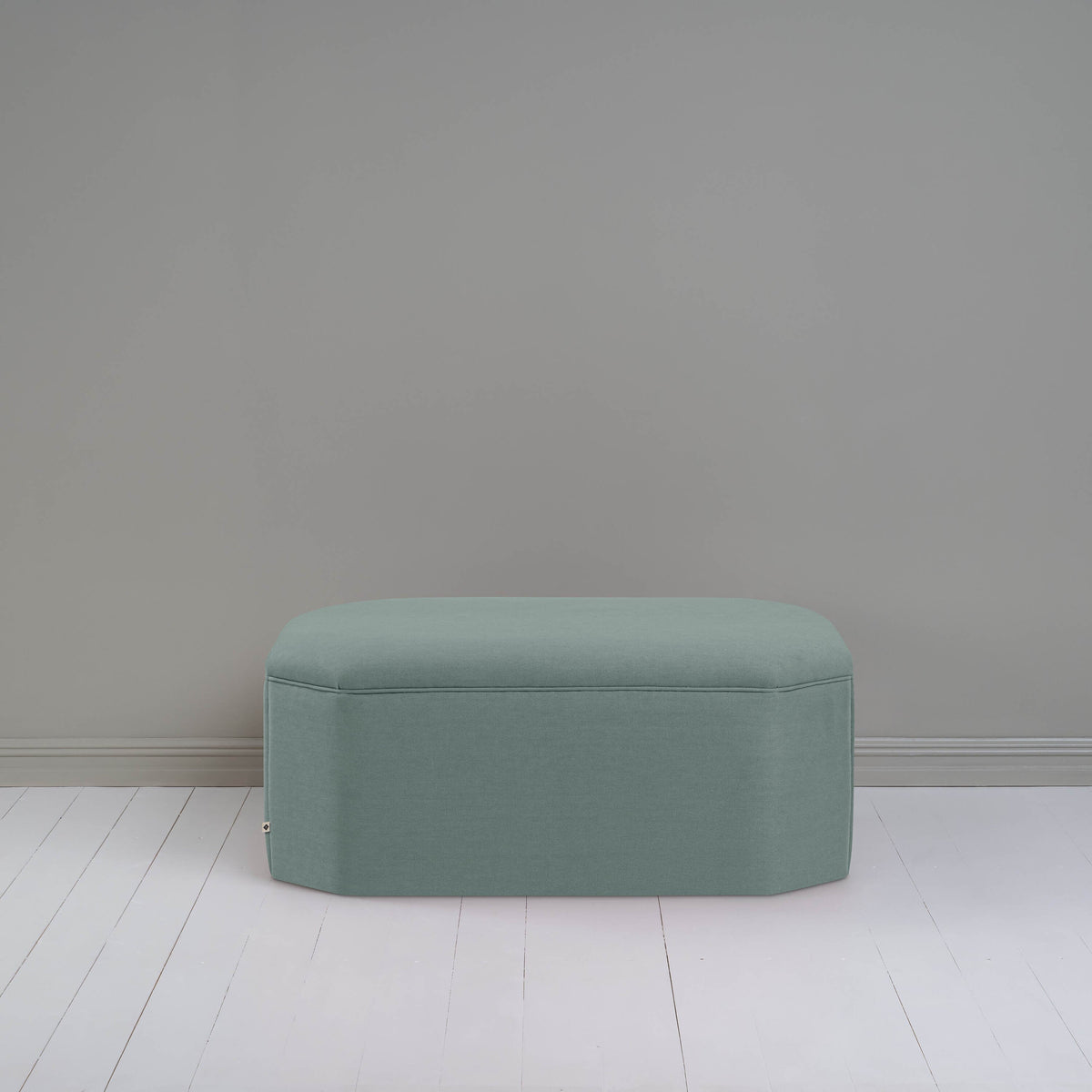 A small light blue ottoman, perfect for adding a touch of color and comfort to any room.