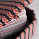 Closeup of Open Lid Hexagonal Storage Ottoman in Regatta Cotton, Flame - Nicola Harding