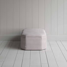 Stylish striped ottoman against white flooring. Side View - NiX
