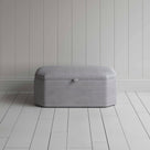 Stylish grey ottoman against white flooring. Front View - NiX