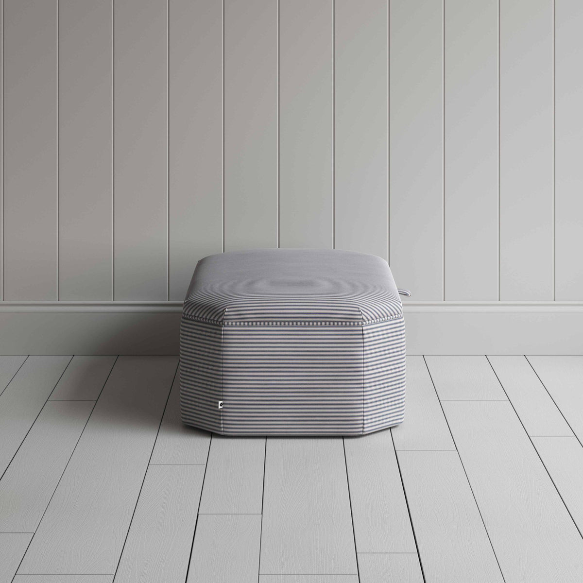 Stylish grey ottoman against white flooring. Side View - NiX