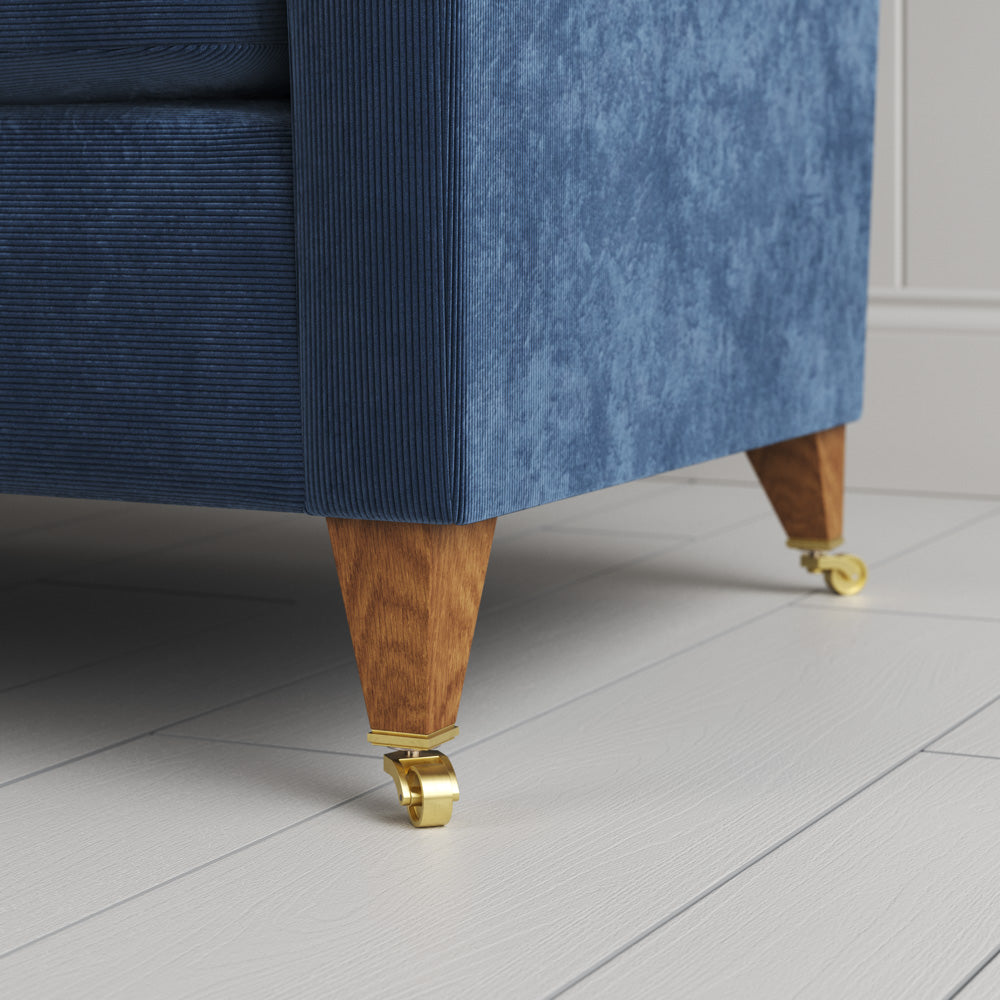  Idler 4 seater sofa close-up detail of tapered timber legs with castors by NiX. 