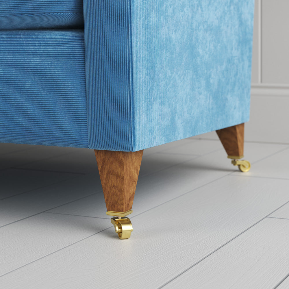  Idler sofa close-up detail of tapered timber legs with castors by NiX. 