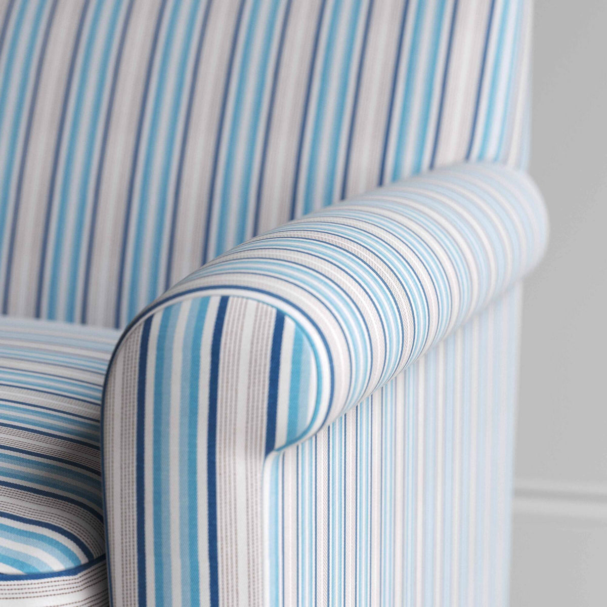 Close-up of the tailored blue cotton linen armrest on the Idler by Nix.