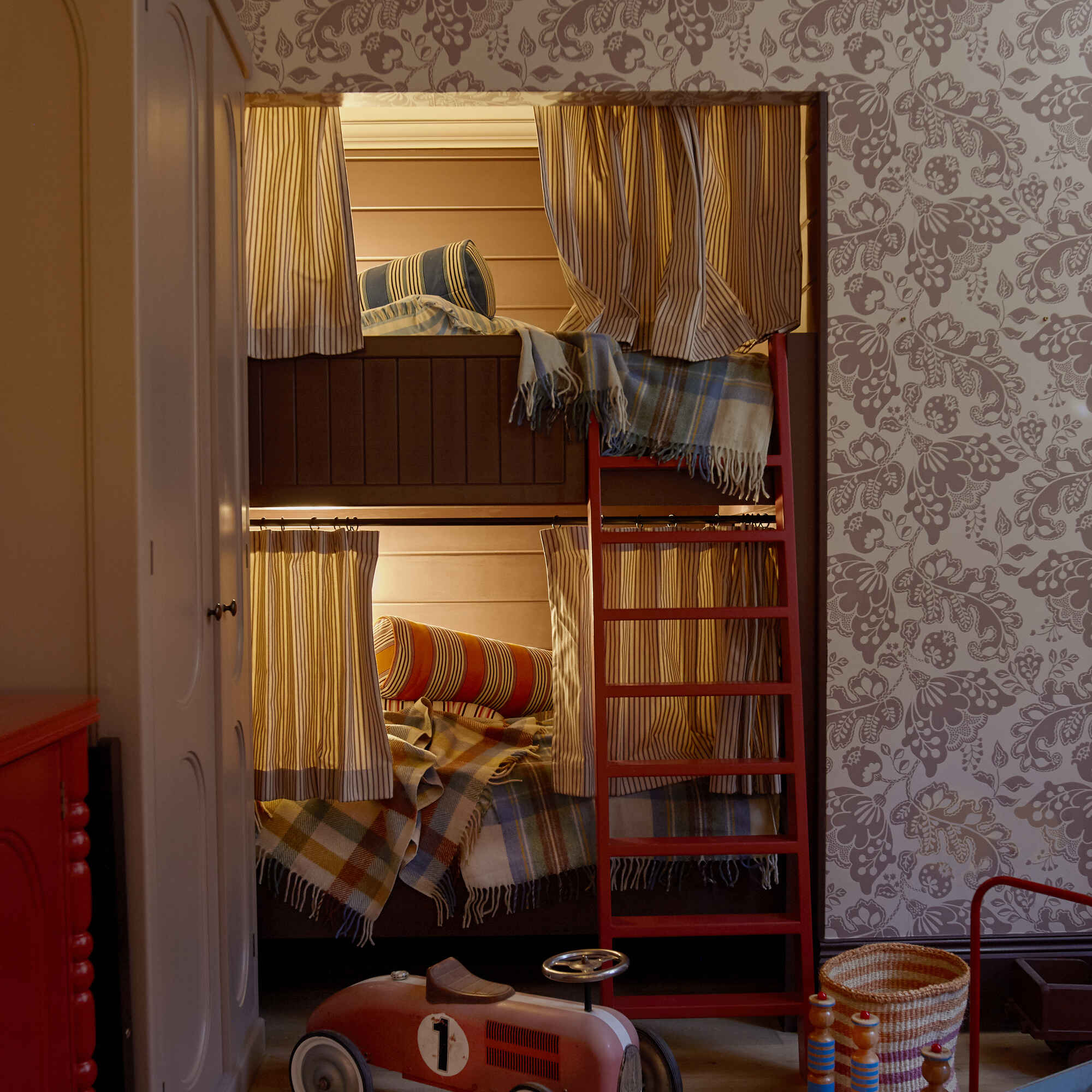  Kids' room featuring two bunk beds, decorated with Albion wallpaper in Mauve, designed by Nicola Harding & Co. 