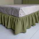 Cloud Nine Upholstered Bed in Intelligent Velvet Green Tea with Ruffled Valance, showcasing the edge design and a neatly tucked-in bedsheet.
