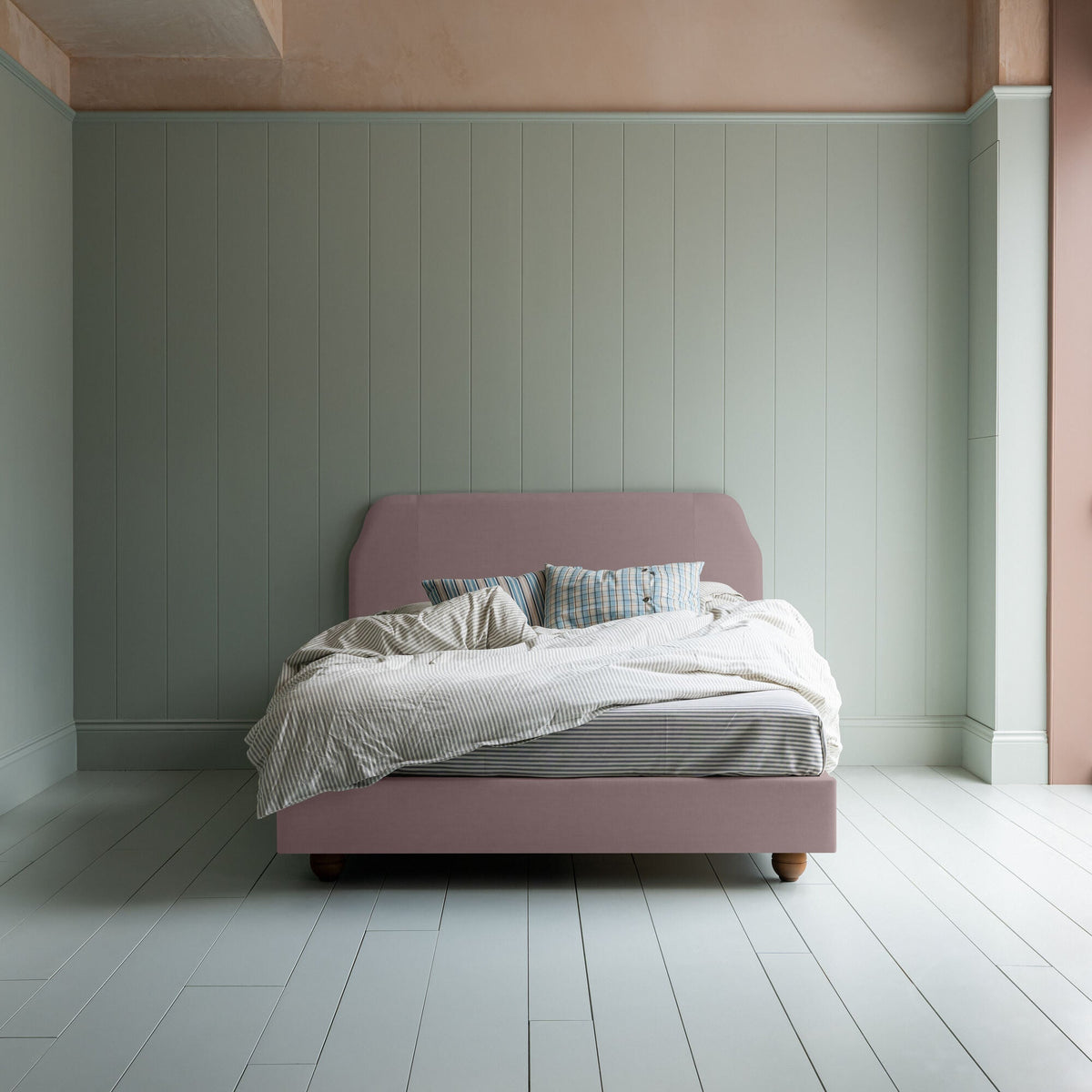 Dream Ticket upholstered bed in Laidback Linen Heather, styled without a valance, shown from the front with pillows and a blanket.