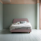 Dream Ticket upholstered bed in Laidback Linen Heather, styled without a valance, shown from the front with pillows and a blanket.