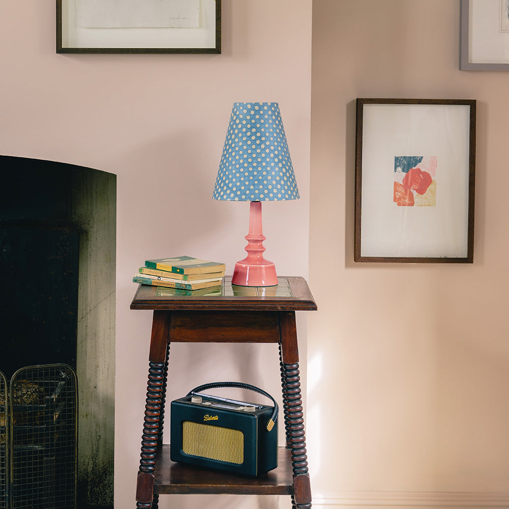  Ditsy Tall Tapered Lampshade in Dotty Sky Blue with Blush Pink Ceramic Table Lamp Base, Accompanied by Books and an Old Radio on Side Table Bottom Shelf - By NiX 