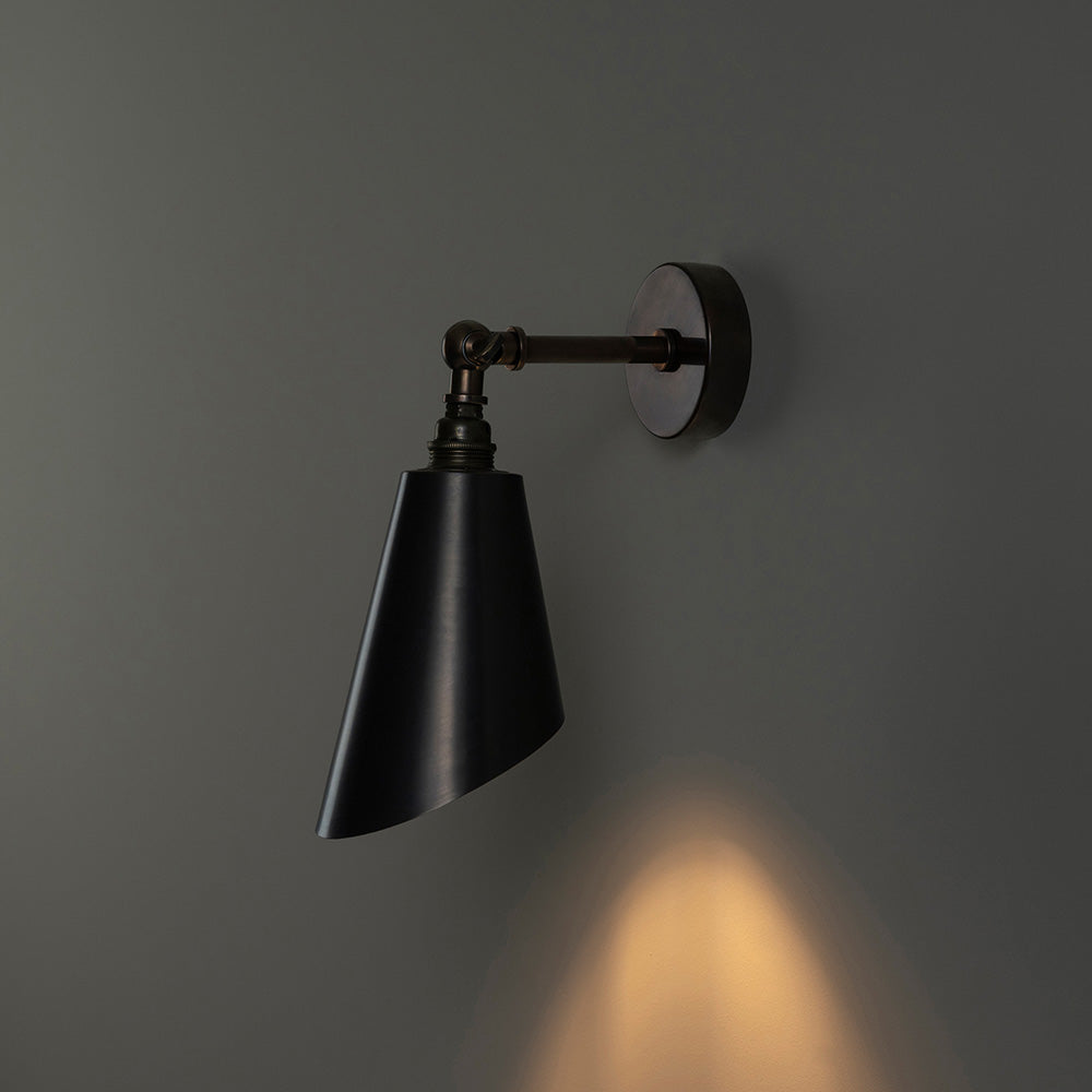   Black wall lamp with white light illuminating the room. 